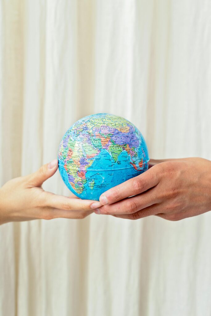 Photo depicting hands holding a globe, symbolizing unity and world peace.